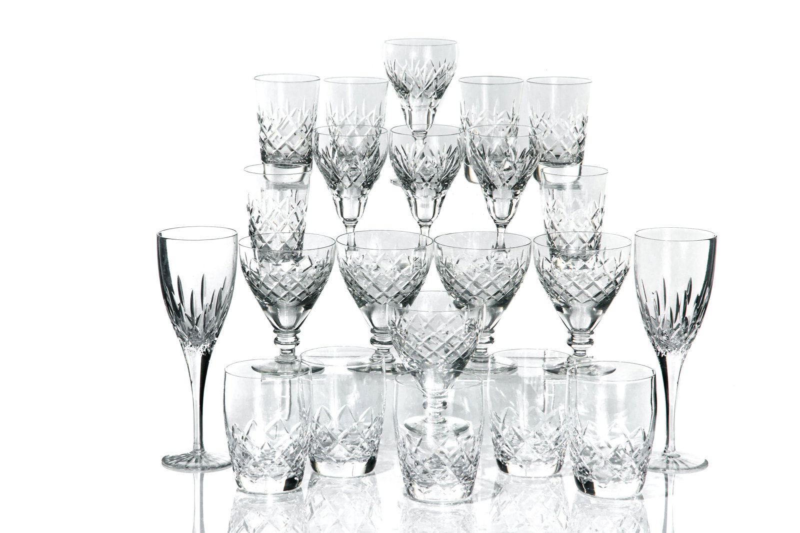 22 PCS ASSORTED ENGLISH CUT GLASS STEMWARE: Including two Doulton International flutes, five Stuart whiskey tumblers, five Webb Corbett wine goblets and six flat juice glasses and four Tudor claret wine glasses. English, 20th C, with correspond