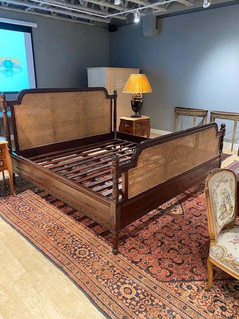 CANED FRENCH STYLE KING BED: Carved wood frame with double sided caning on the headboard and footboard, in the manner of a French antique, likely made elsewhere. Dimensions of bed frame: H. 53 1/2" Inside frame: W. 80 1/2" D. 80