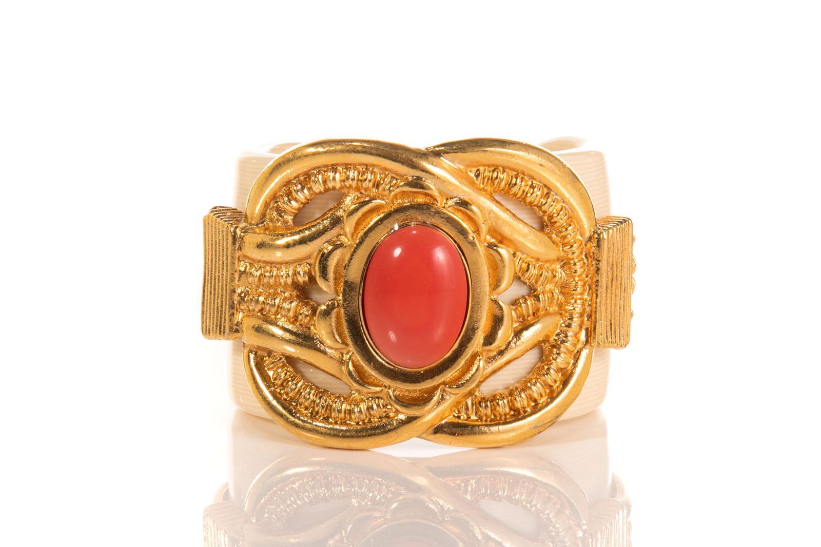 VINTAGE ESCADA CUFF BANGLE: A contemporary Italian statement cuff bracelet by Escada, French ivory with gilt metal overlay and faux coral stone, signed on inside of cuff. Diameter: 6cm