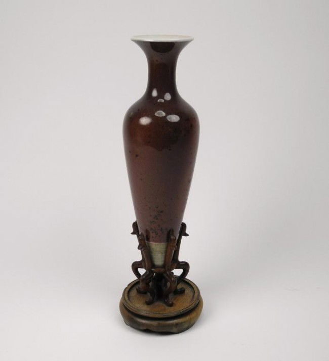 CHINESE PORCELAIN PEACH BLOOM VASE: Amphora in style with an unlglazed tapered base. The base with a six character Kangxi mark in blue. Old weighted wood base. Height of vase 16.1 cm (6 3/8")