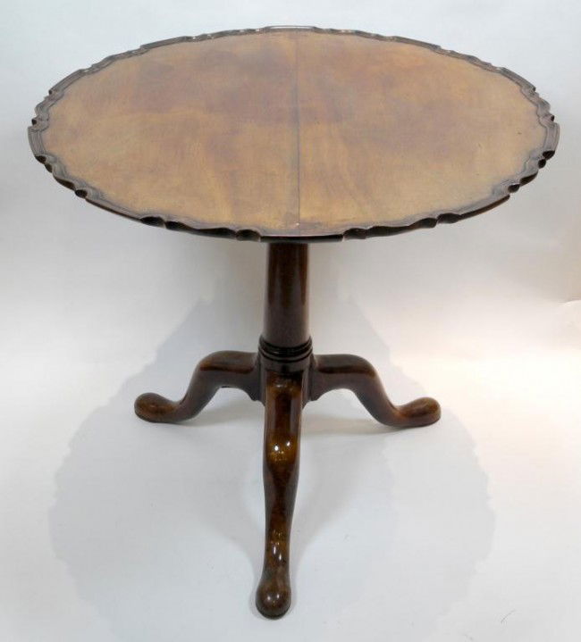 GEORGIAN TILT TOP OCCASIONAL TABLE: Round pie crust bird cage fitted tilt top with tripod footed base on pad feet. England, 1750. Diameter 29 1/2"