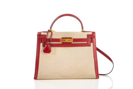 VINTAGE HERMES CANVAS & LEATHER KELLY BAG: Tan canvas body with red leather lining. With original key and lock. Marked Hermes Paris, Made in France. W. 33cm (13in.) H. of body: 22.8 (9in.)