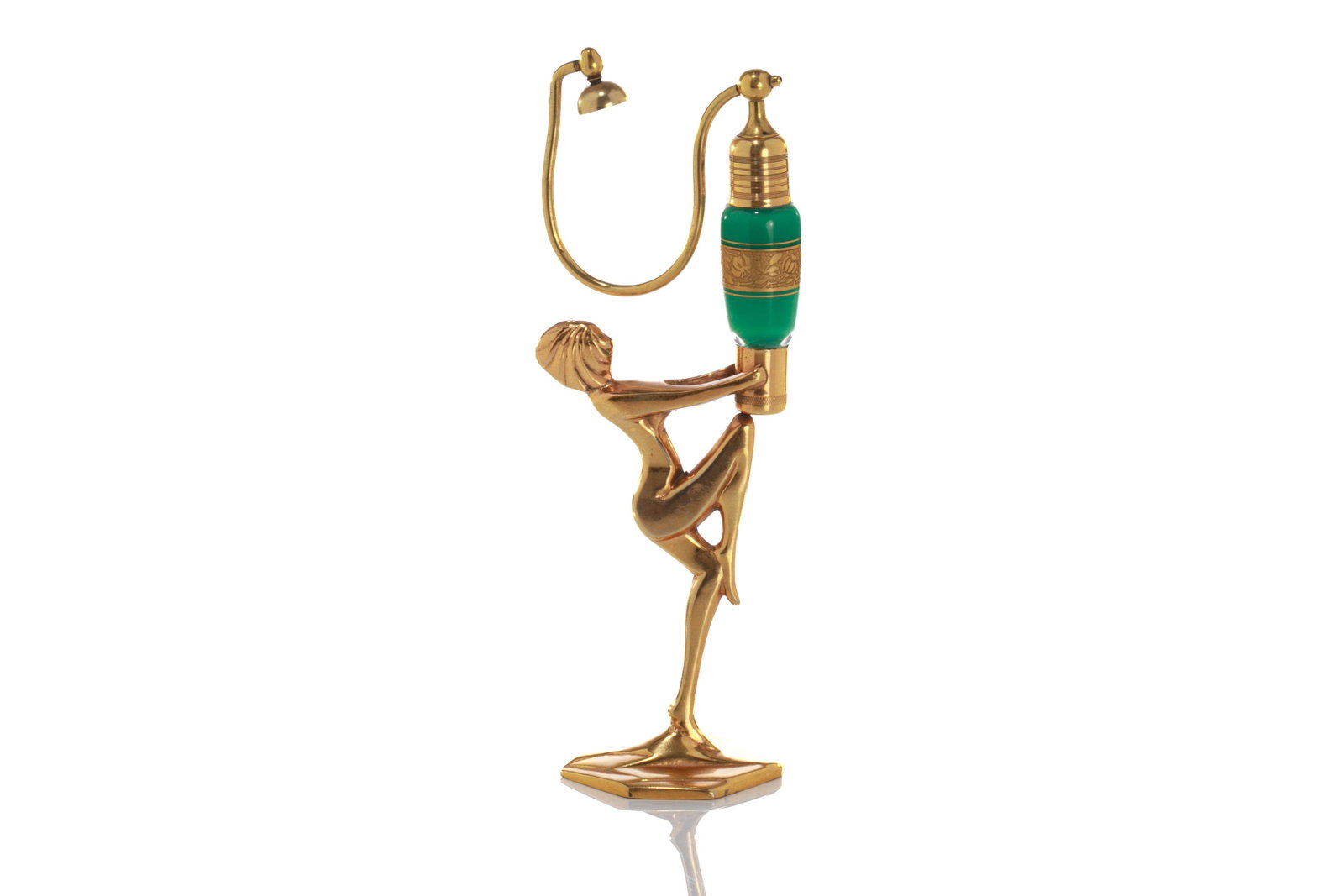 ART DECO VOLUPTE FIGURAL ATOMIZER: With a nude female holding up a coloured glass perfume bottle and extended metal atomizer. Original paper label and patent pending marks to base. H. 23.5 (9 1/4 in.)