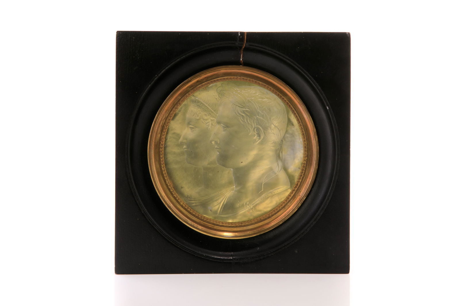 GLASS PORTRAIT OF NAPOLEON AND JOSEPHINE: A cast glass profile portrait with foil backing of Napoleon and Josephine by Bertrand Andrieu early 19th century. Mounted in a circular mat set in an ebonized frame. Dia. of portrait: 11 cm (4 1/4 in.