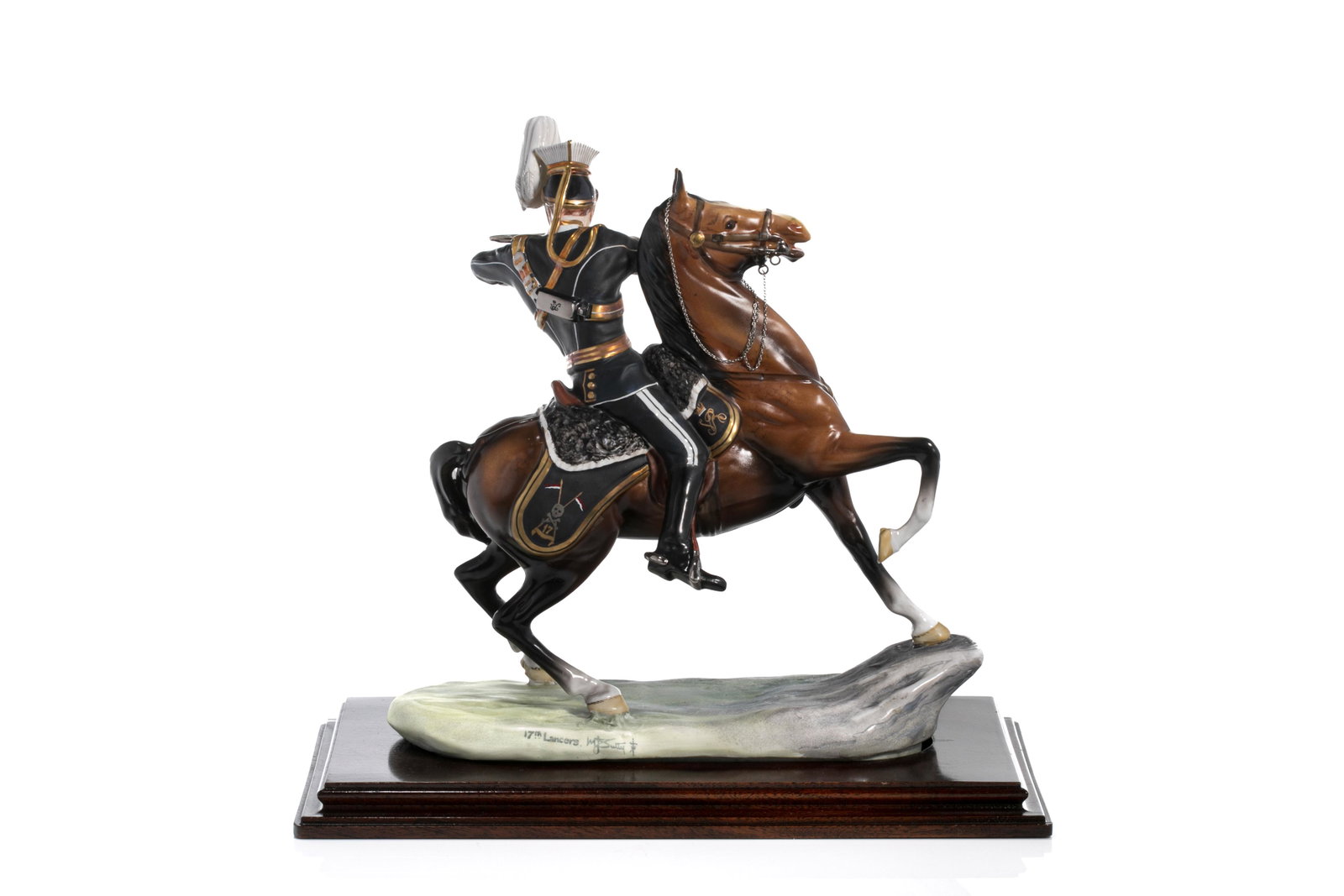 MICHAEL SUTTY PORCELAIN 17TH LANCERS FIGURE: Porcelain figure of an English 17th Lancer figure on horse back, posed mid-fire of his pistol. Hand painted Michael Sutty mark to side with moulded wood carved base, 20th C. H. without base: 29cm (11 