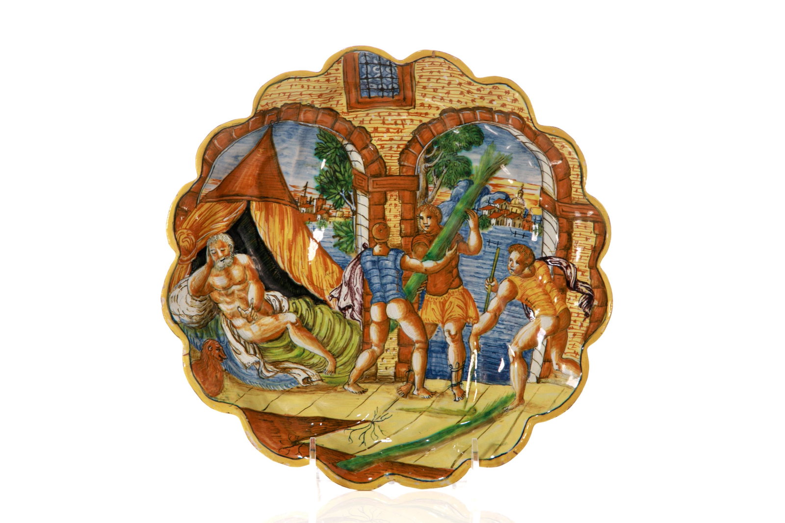 ANTIQUE ITALIAN MAJOLICA POTTERY ISTORIATO PLATE: Painted with a figural scene of undetermined classical myth depicting three soldiers presenting to a nude figure, likely a god with surrounding architectural scene in polychome blue and ochrehues. Han