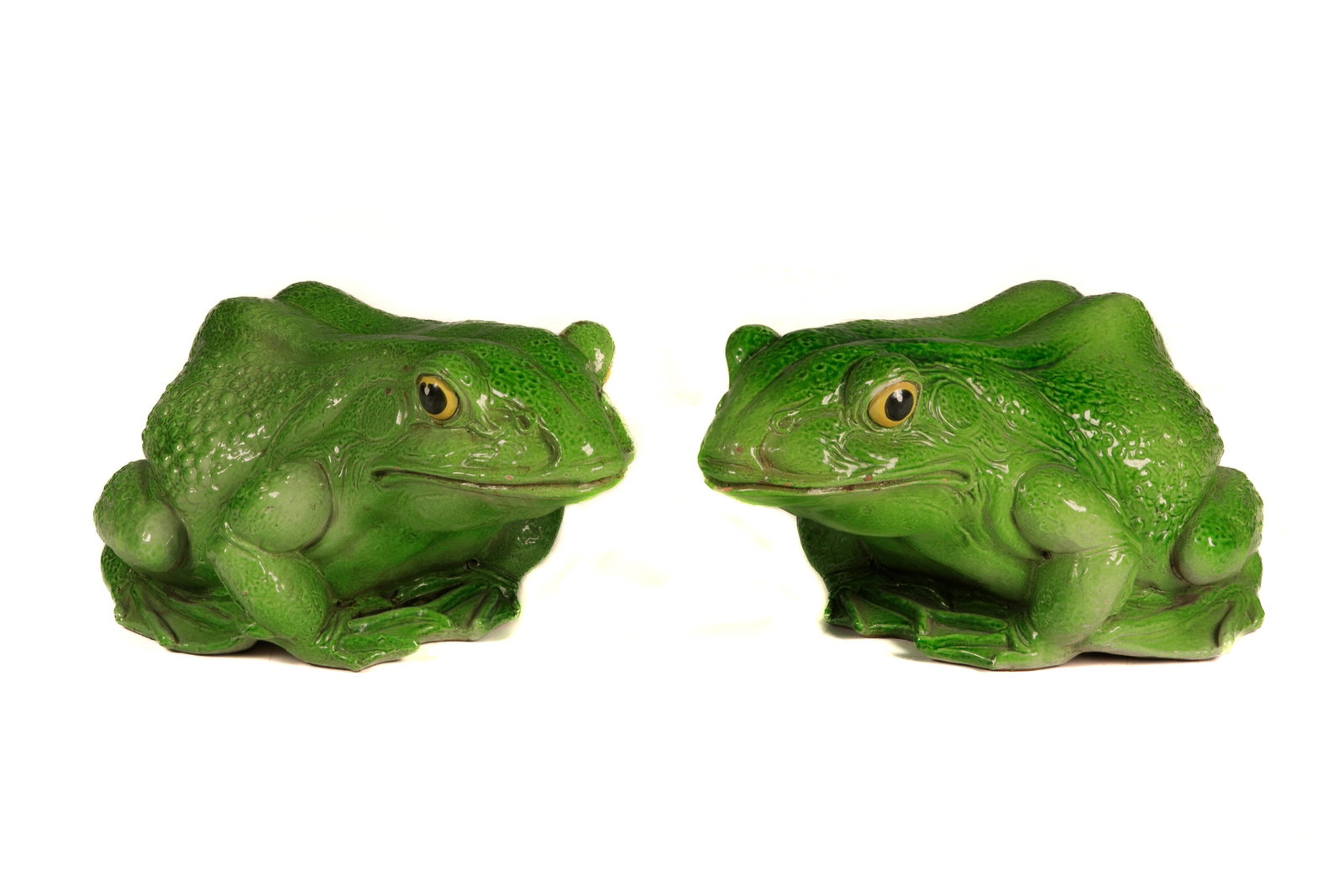 PAIR OF ITALIAN POTTERY FROGS: Modeled after realistic frogs, green painted. Impressed mark Made in Italy. L. 63.5 cm (25 in.)Generally in good condition with minor chipping to the glaze.