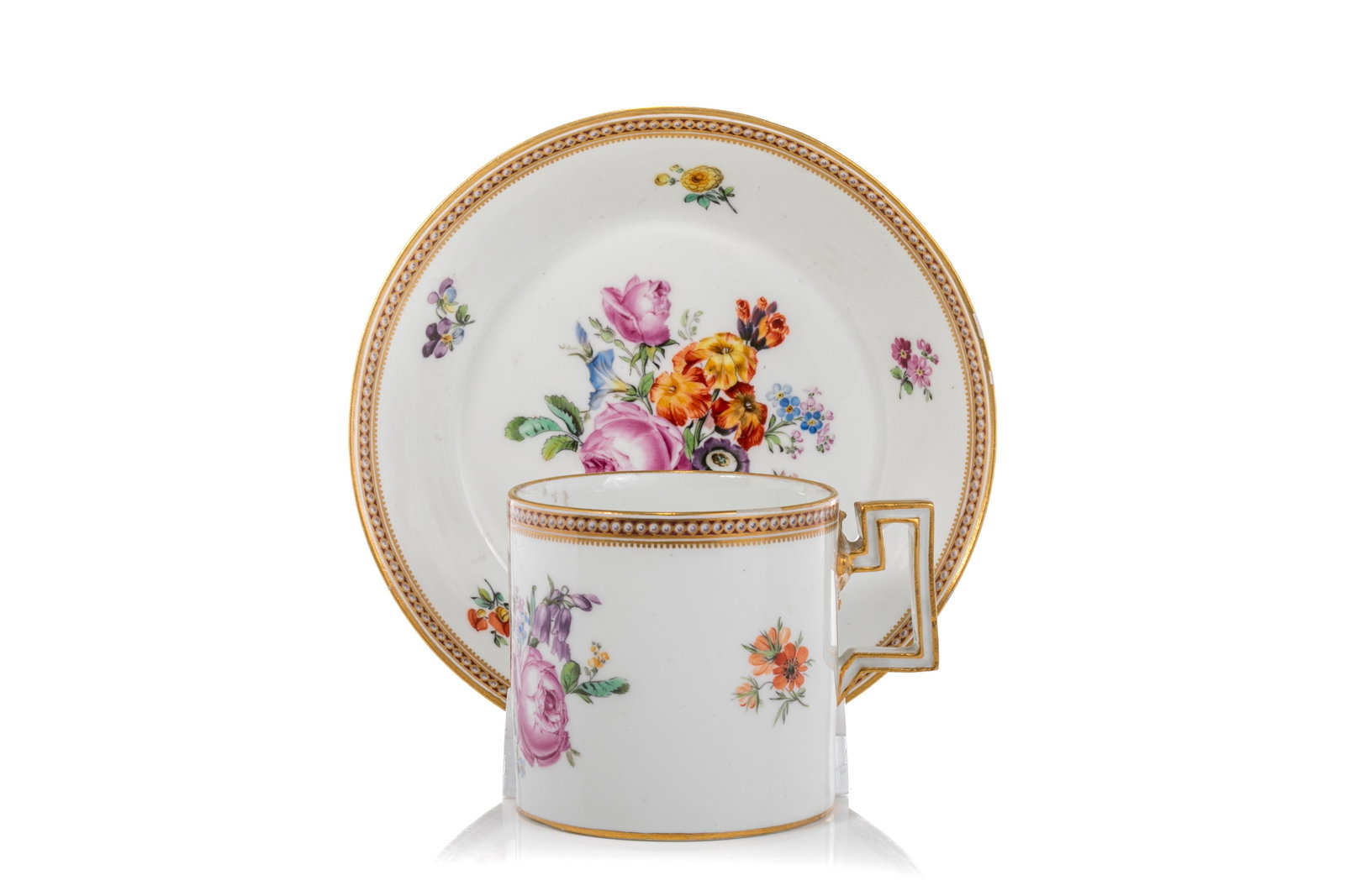 18th C MARCOLINI MEISSEN PORCELAIN CAN & SAUCER: White porcelain ground with deutsche blumen polychrome spray, the can with angular, trapezoidal handle, both with repeating beaded motif to rim. Blue crossed swords mark to base with Marcolini star. D