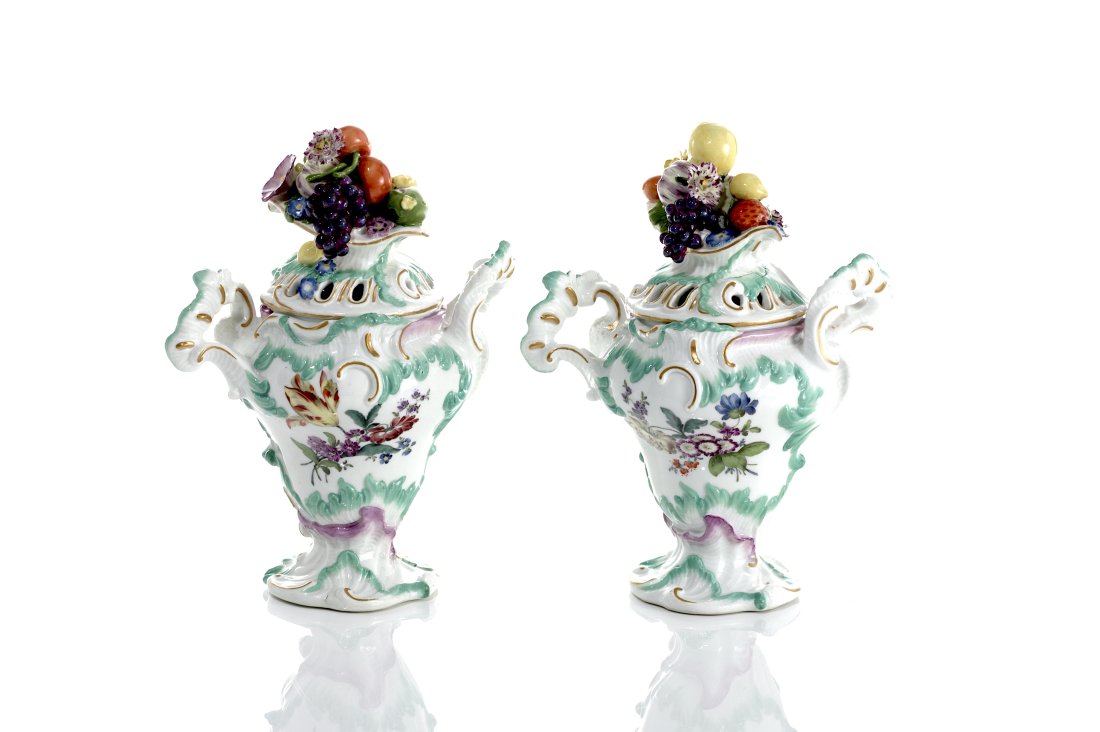PAIR OF MEISSEN PORCELAIN COVERED POT POURRI URNS: Moulded bodies with exaggerated Rococo handles in turquoise glaze, each painted with a floral bouquet, the pierced lids beautifully accented with a towering fruit finial, Cross sword marks, first half