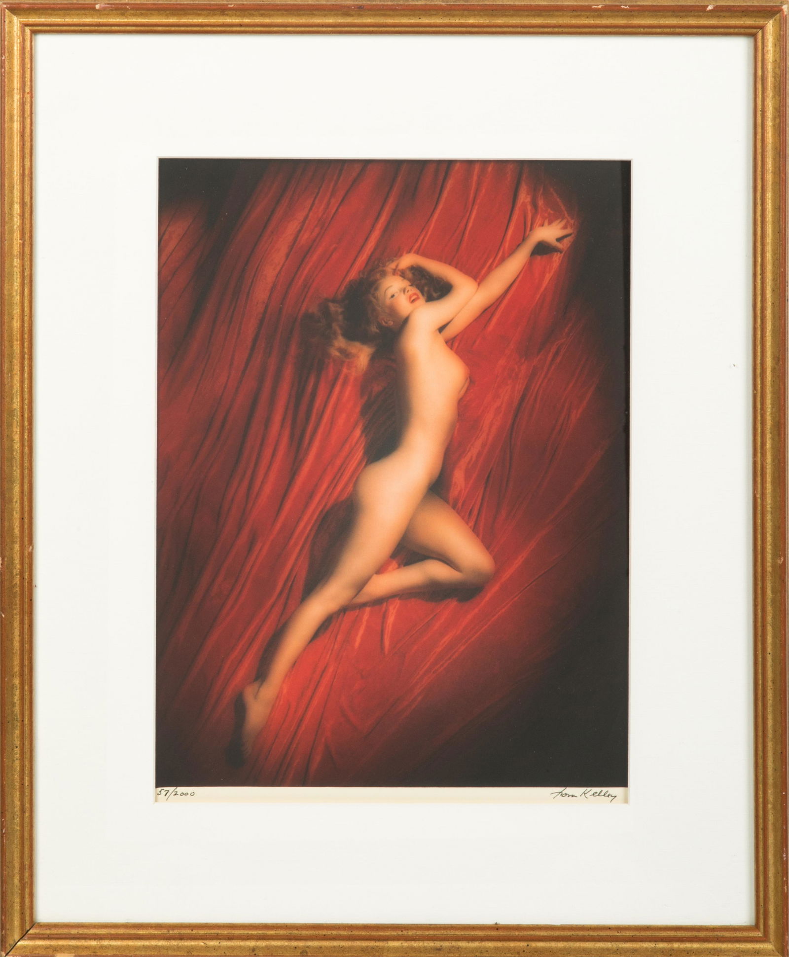 MARILYN MONROE ON RED VELVET (TOM KELLEY): A cibachrome image depicting Marilyn Monroe in her famous "red velvet" nude pose. From a limited edition series numbered "57 / 2000" and signed by Tom Kelley in black ink in the lower margin. Included