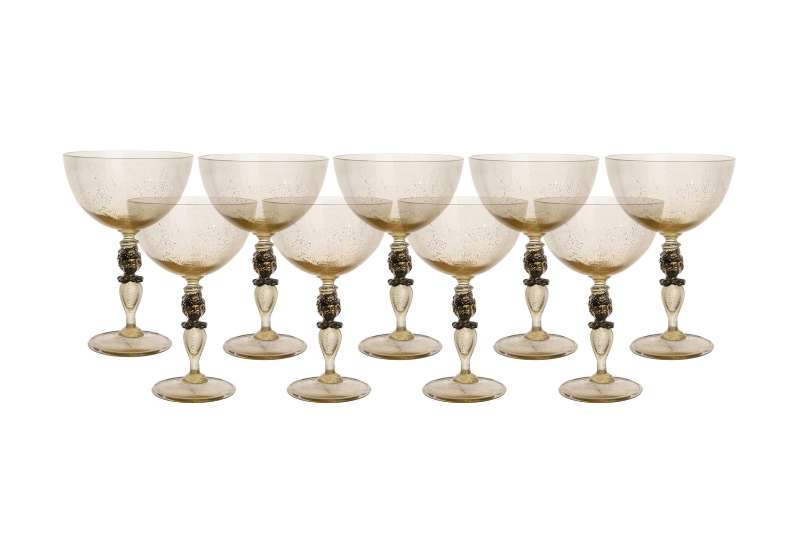 NINE MURANO GLASSES PUTTI WINE STEMS: Nine clear blown glass champagne coupes with figural knoped stems of puttis, sat on round foot. Murano, 20th C. H. 14.9cm (5 7/8in)