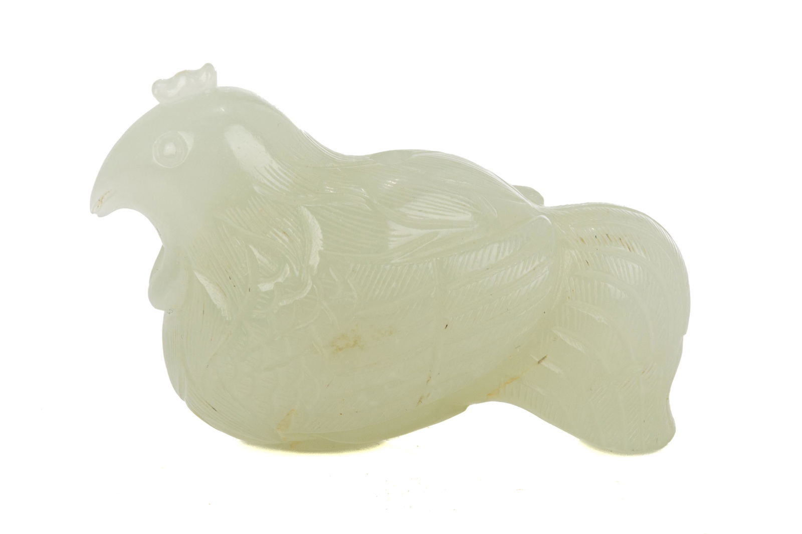 A CHINESE WHITE JADE CARVED HEN: Chinese, 19th to 20th century, late Qing dynasty, overall in even white to pale celadon tone, finely carved of a hen. L. 5 cm (2 in.)