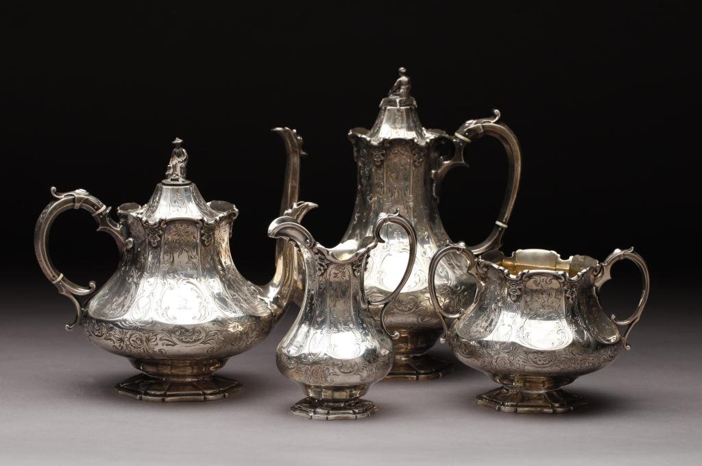 VICTORIAN SILVER CHINOISERIE TEA & COFFEE SERVICE: Robert, James & Josiah Williams, Exeter, 1851, with figural finials and engraved decoration, comprising coffee pot, teapot, cream jug & sugar basin, crested, 2188 gm, height of coffee pot 10.5 in (27 