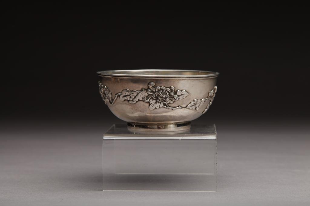 CHINESE EXPORT SILVER BOWL, WANG HING & CO.: Exterior is decorated with chased and embossed chrysanthemums, base is marked Wang Hing Hong Kong; late 19th/ early 20th century. W. 11.7cm (4.6 in.)
