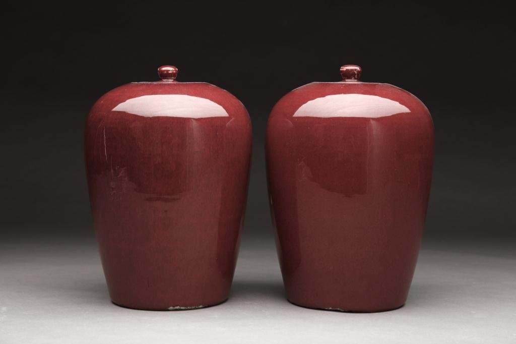 TWO CHINESE OX BLOOD PORCELAIN JINGER JARS: With lids.19th century. H. 30.5cm (12 in.)
