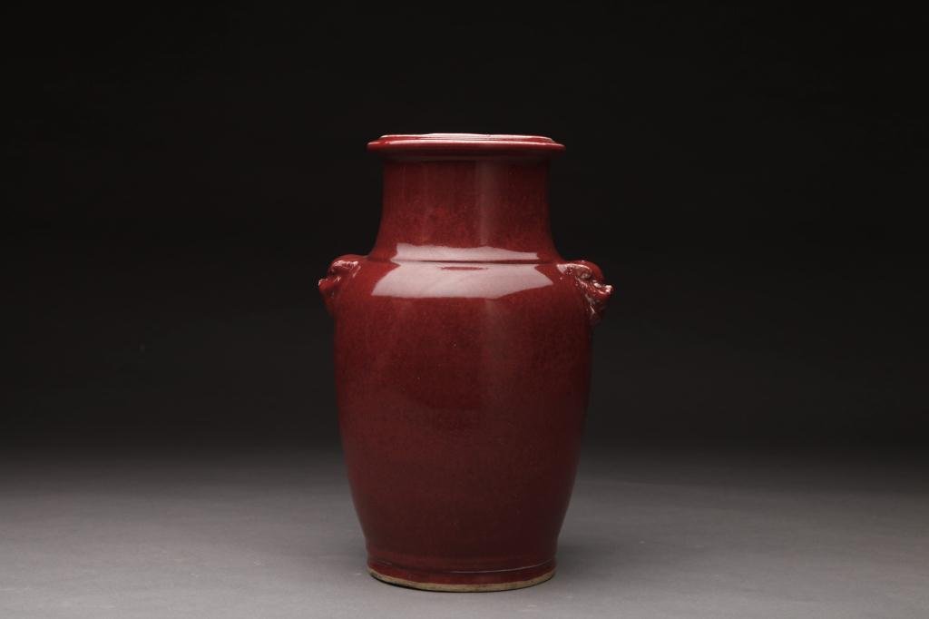CHINESE OX BLOOD GLAZED PORCELAIN VASE: With mounted lion handles on sides. H. 39.5cm (15.5 in.)