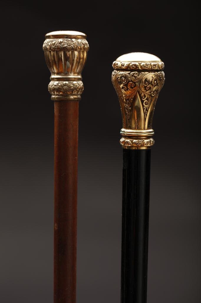 TWO GOLD PLATED KNOB HANDLED WALKING STICKS: One has delicate foliage decoration, inscribed "John S. Williams Xmas. 87" L. 92cm (36 1/4 in.); the other with "G. E. P. SALEM MASS" engraved on knob and decorated with bands of flowers. L 94cm (37 i