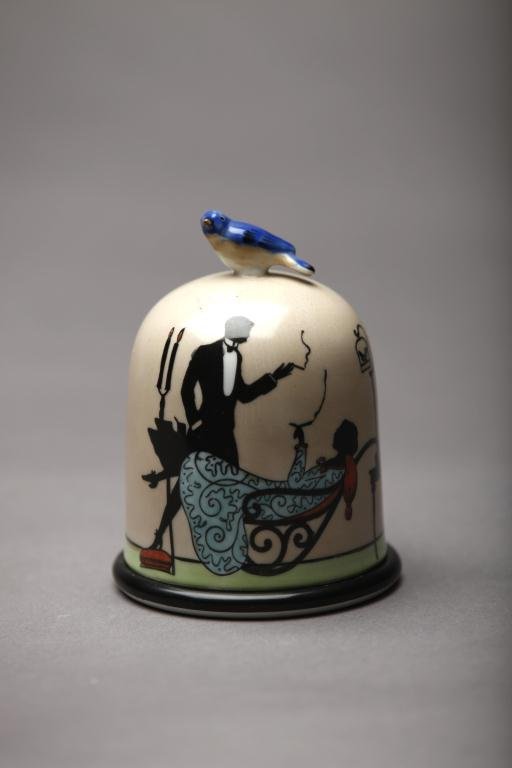 NORITAKE DOMED CIGARETTE BOX: Bird cage-form with silhouette motif of a couple smoking by candle light, bird finial. Green M-in-Wreath, H 12 cm. (4 3/4 in.)