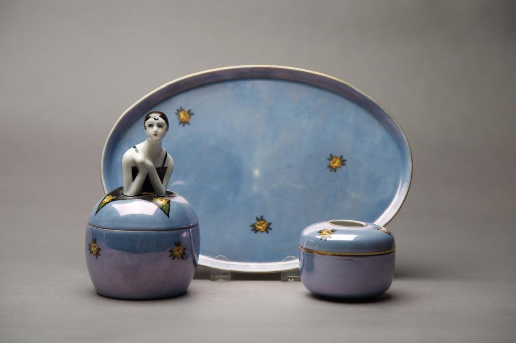 NORITAKE THREE PIECE DRESSER SET: Blue lustre with yellow roses. Including a hair receptacle, figural powder jar and tray (minor flake). Green M-in-Wreath, L 27.5 cm. (10 7/8 in.)
