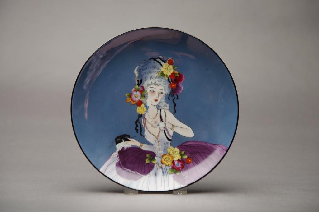 NORITAKE LUSTRE PLATE: Blue ground with a lady in a masquerade ball gown and mask. Red M-in-Wreath, Dia 21.6 cm. (8 1/2 in.)