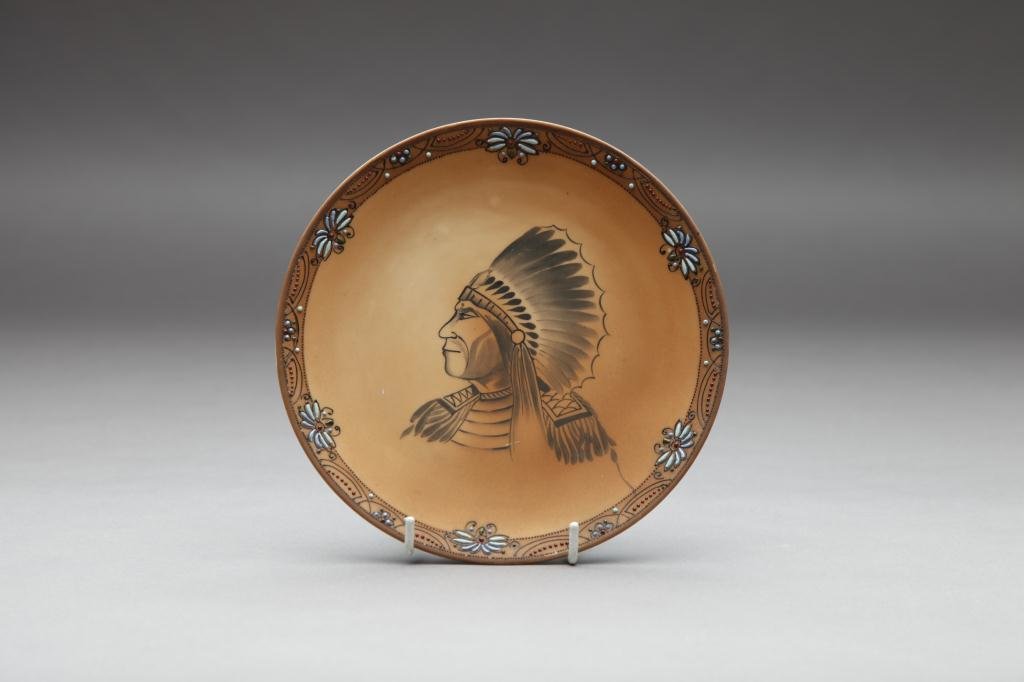 NIPPON HAND PAINTED PLAQUE: With an Indian head in profile and moriage border. Green M-in-Wreath, Dia 19.5 cm. (7 3/4 in.) One bead missing