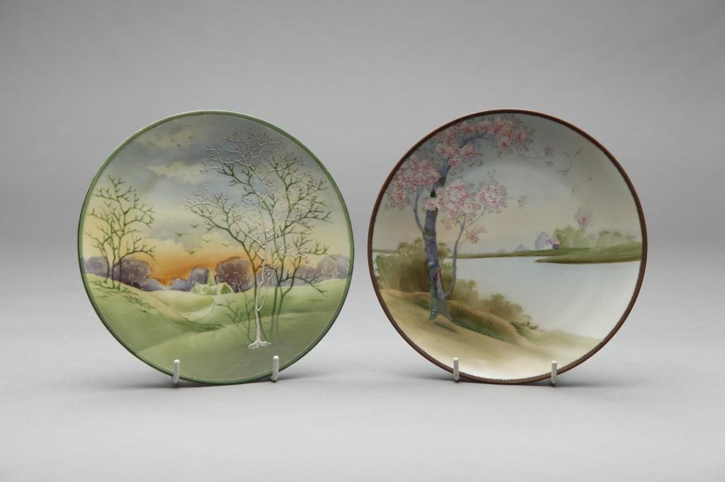 TWO SMALL NIPPON HAND PAINTED PLAQUES: Each a landscape motif with very fine moriage work on the trees. Green and blue M-in-Wreath, Dia 19.5 cm. (7 3/4 in.)