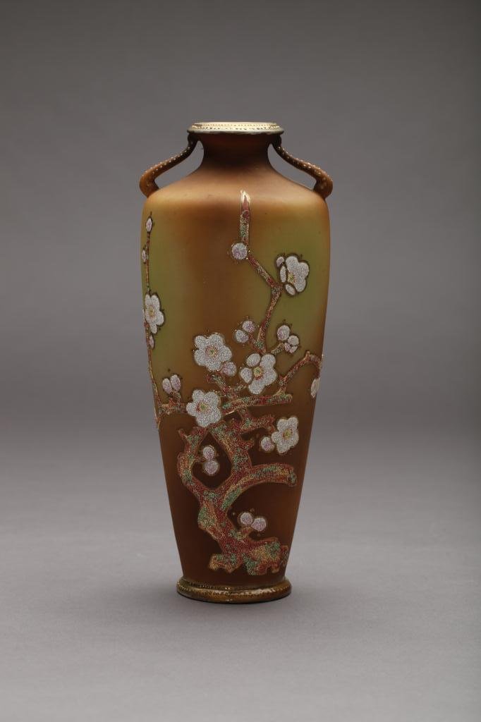 NIPPON CORALENE DECORATED TWO-HANDLED VASE: Beaded glass pink and white cherry blossoms on a burn orange satin ground (restored). Mark worn, H 27.3 cm. (10 3/4 in.) Restoration to base