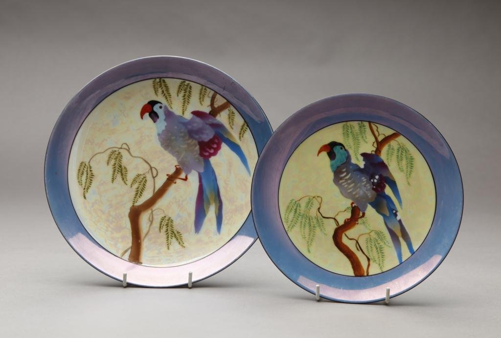 TWO HAND PAINTED NORITAKE PARROT PLATES: Each with a parrot perched in a Wisteria vine. Red & Green M-In-Wreath, Dia of largest 25 cm. (10 1/8 in.) Minor loss to paint on parrots