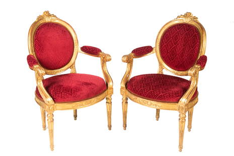 PAIR OF PERIOD 18th C GILTWOOD ARMCHAIRS: Pair of French Louis XVI armchairs. In the manner of Louis Delanois (1731-1792). Oak frames, carved and gilded. Upholstered in maroon, patterned velvet. circa 1780. Supporting documentation suggesting