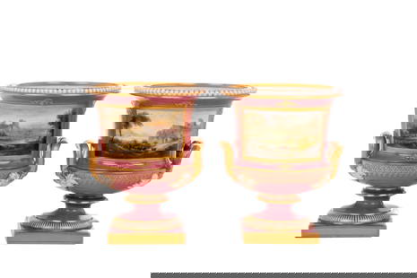 PAIR OF ROYAL WORCESTER PORCELAIN LANDSCAPE VASES: Two pink ground English porcelain vases or urns with a hand painted landscape scene with beaded rim and gilded accents. Landscape scene signed H. Davis. Marked to underside Royal Worcester England 225