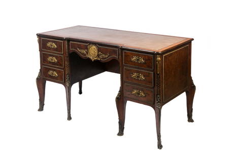 ANTIQUE FRENCH BRONZE MOUNTED DESK: Burled wood desk with bronze mounts throughout and a central figural ormolu panel on the central drawer, leather top, French, late 19th C. H: 31'' W: 55'' D: 25''