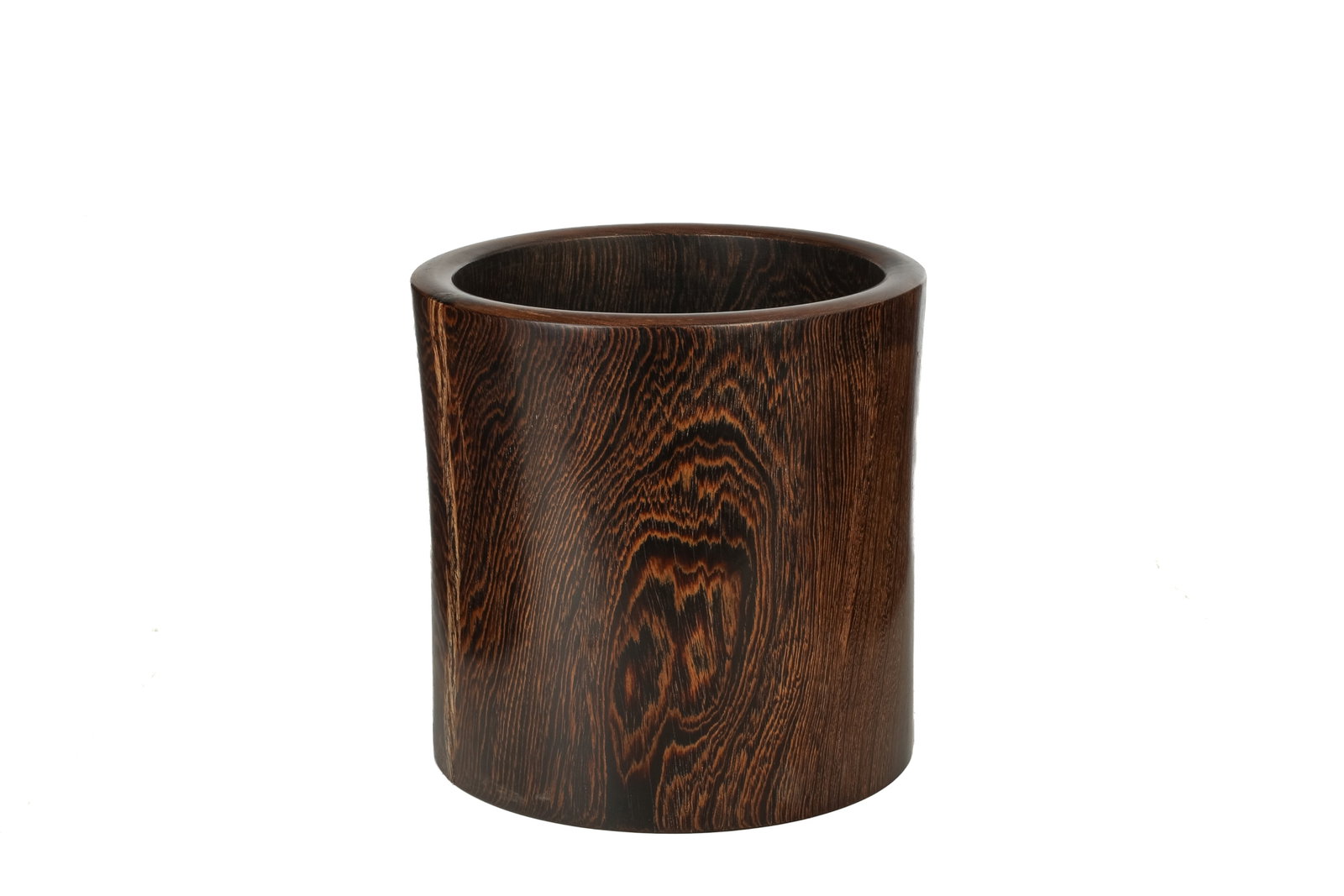 A CHINESE JICHIMU CARVED BRUSHPOT: Chinese, 19th century, a jichimu (chicken wing) carved brush pot of cylindrical form with a slightly flared mouth. H. 23.8 cm (9 3/8 in.)