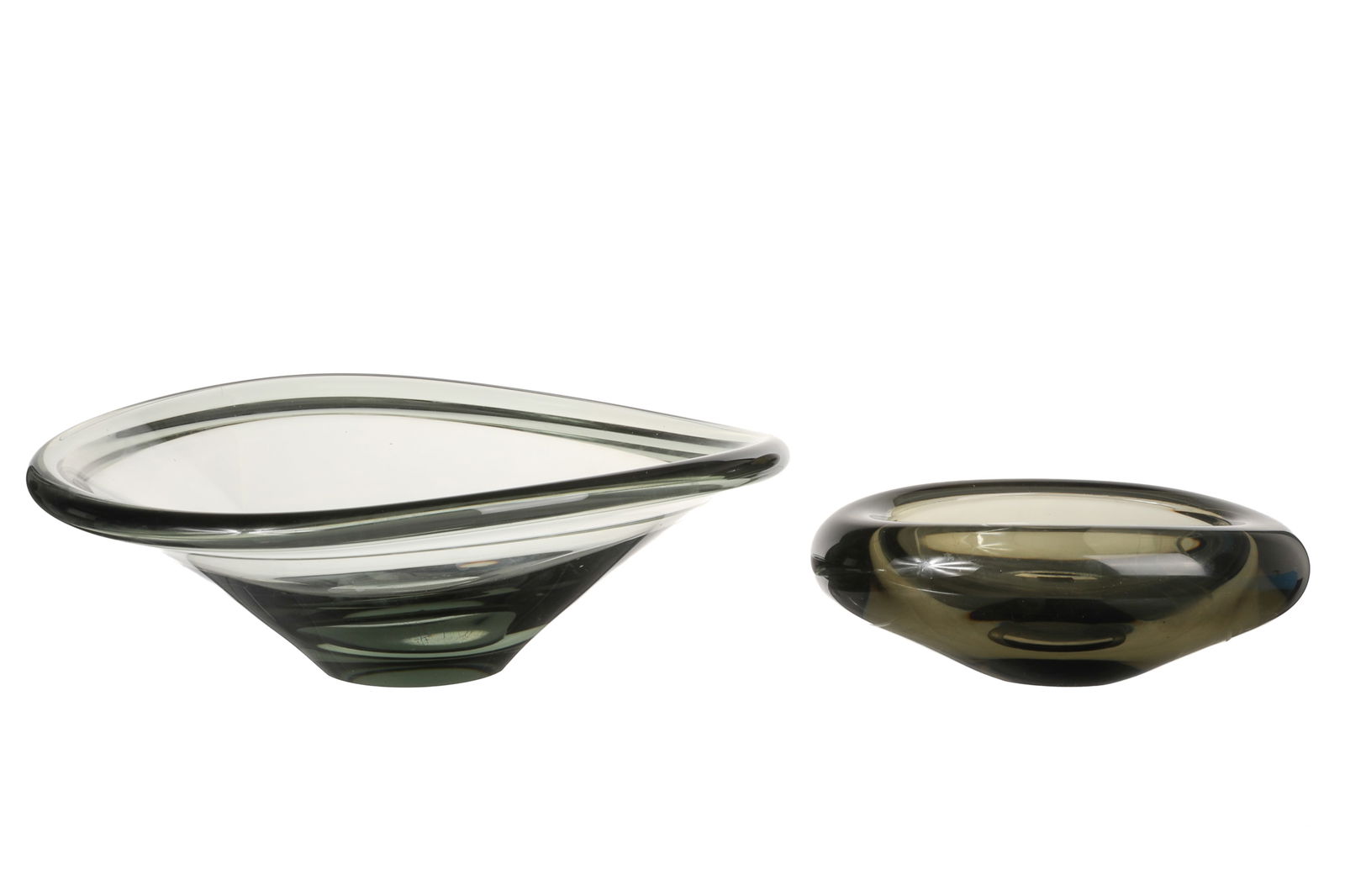 TWO HOLMEGAARD PER LUTKEN GLASS BOWLS: Including a large smoked glass 'slung bowl' , etched Holmegaard 1966, and an ovoid shape smoked glass bowl, etched Holmegaard 1961. Denmark, 20th century. H. of largest: 10cm (4 in.)