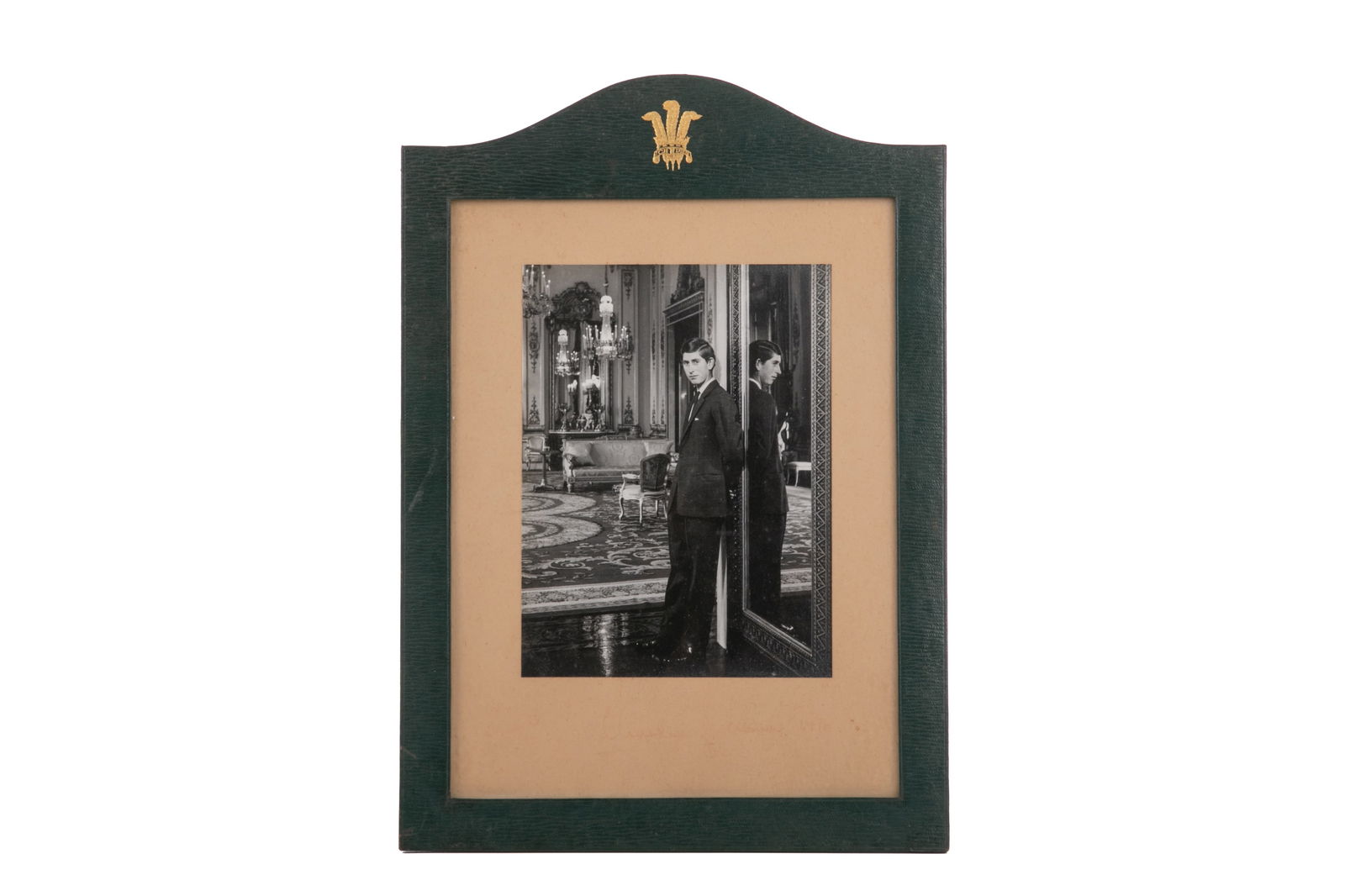 ENGLISH LEATHER PICTURE FRAME WITH ROYAL PORTRAIT: A black and white photography of a young Prince Charles in Buckingham Palace, 1968, taken by Cecil Beaton. Back paper stamped with the photographer CB/996/10. Faint signature on bottom of paper. In a