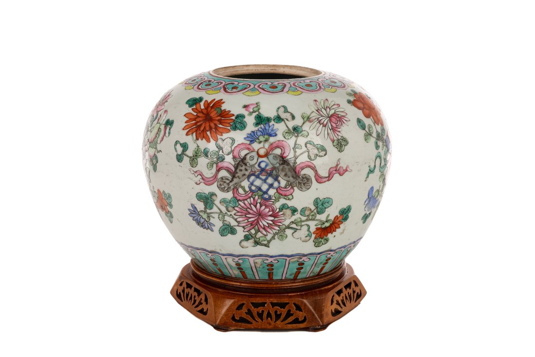 CHINESE FAMILLE ROSE PORCELAIN JAR W/ STAND: Chinese, a famille rose ovoid jar decorated with auspicious objects and floral motifs throughout its body, having a custom wooden stand. H. of jar: 19 cm (7 1/2 in.) H. with stand: 23.4 cm (9 1/4 in.)