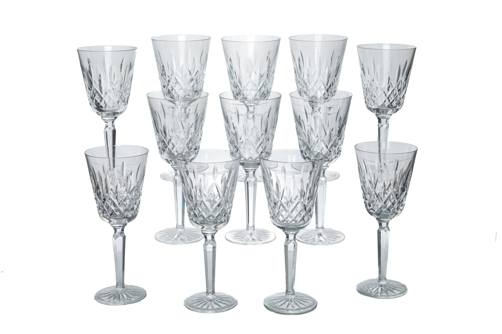 TWELVE LISMORE PATTERN WATERFORD WINE GLASSES: Twelve Waterford wine glasses in the 'Lismore' pattern with vertical cuts along the body and diamond cuts along the foot. Ireland, 20th C. H.: 21 cm (8 1/4 in.)