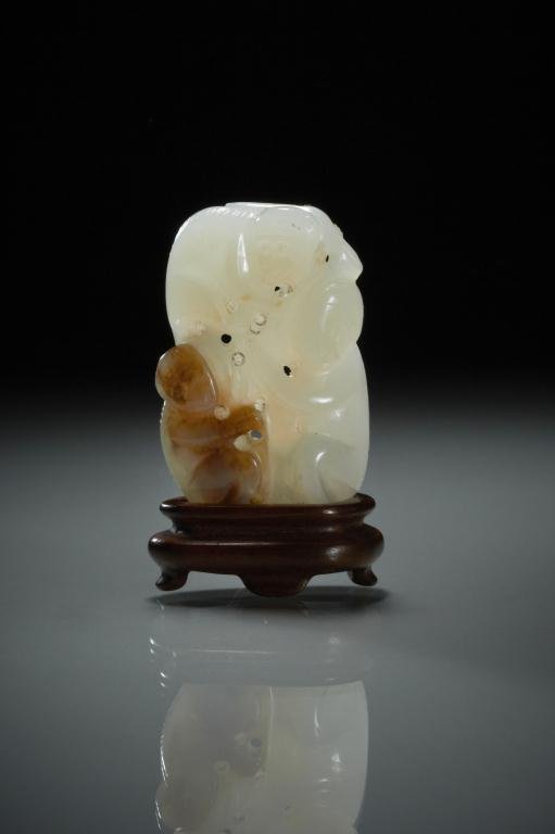 CHINESE FINELY CARVED JADE MONKEY FIGURAL GROUP: 白玉雕猴擺件 White jade with a russet spot, carved as three playful monkeys, on fitted carved wood stand. H. 4.9cm (1 7/8 in.) Provenance: from the collection of Mr