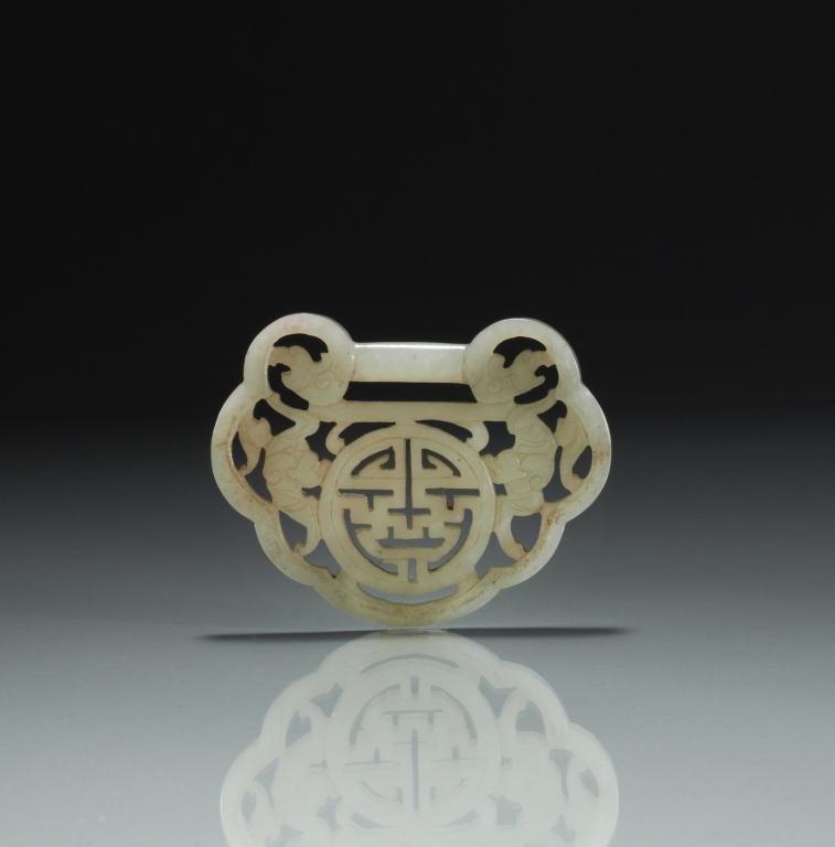 CHINESE CARVED JADE "SHOU" PLAQUE: Gray jade lock-form pendant carved with character "shou" and two bats as symbols for longevity, bordered by stylized dragons. W. 7.6cm (3 1/8 in.) Provenance: from the collection of Mr. Abraham Abraha