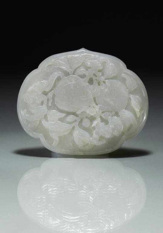 CHINESE WHITE JADE PENDANT: Carved with two peaches and two bats on one side, the back slightly concave with three small piercing. Of semi-translucent white stone. W. 10.5cm (4 3/8 in.) Provenance: from the collection of Mr. Abr