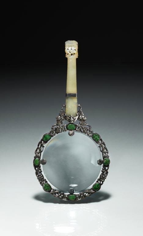 SILVER & JADE MAGNIFIER: Carved jade plaque fitted to silver frame with foliage and bats with eight jadeite inserts. H. 20.2cm (7 7/8 in.)