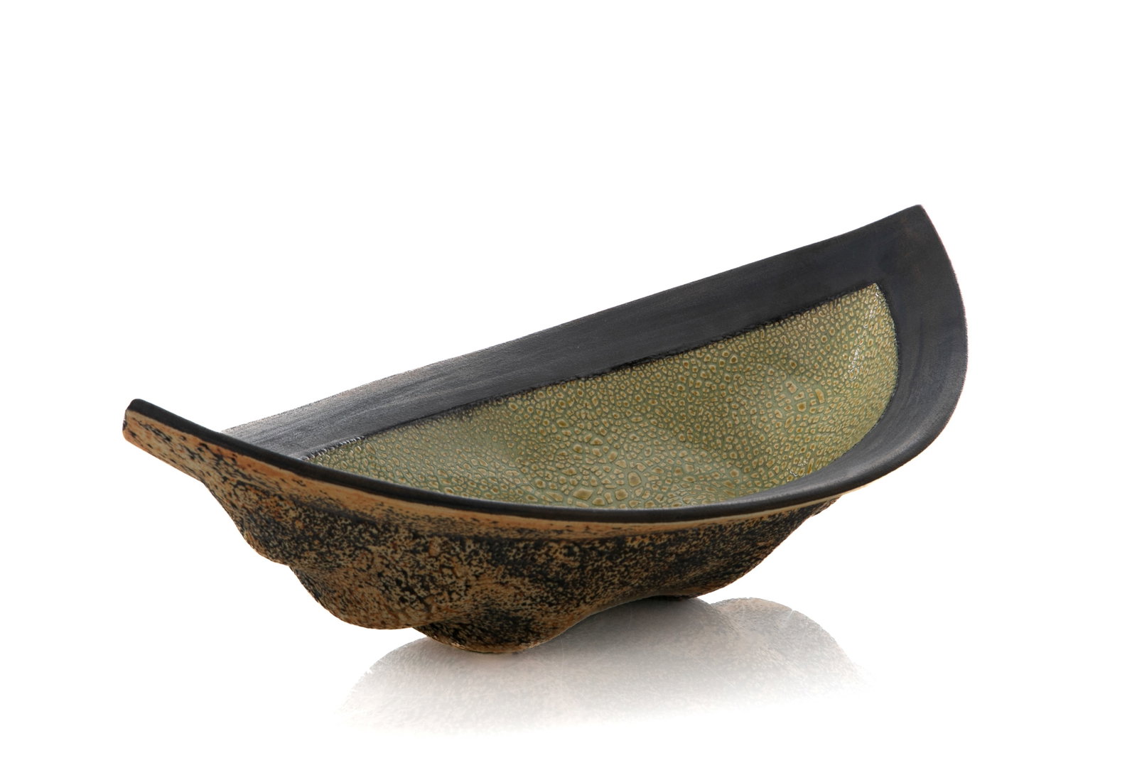 LAURIE ROLLAND (Canadian, b. 1952 - ): A centerpiece bowl with a green and yellow internal with a unglazed charcoal rim and unglazed exterior base.L.: 15.5 in. (39.3 cm) H.: 4.5 in. (11.4 cm) W.: 9.5 in. (24 cm)