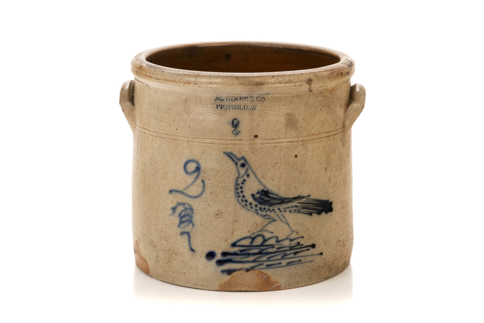 SKINNER & CO.. PICTON C.W. CROCK WITH BIRD: Two gallon open stoneware crock with ear handles, decorated with running bird on a stylized terrain beside the number 2 over a swirl, 1855-1864. Height 23 cm (9 in.)
