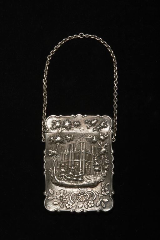 AMERICAN SILVER "CASTLE TOP" CARD CASE: an American coin silver card case. Unmarked circa 1850. Decorated with a floral design and a stylized manor house. 50 gm. 6.5 by 9 cm.
