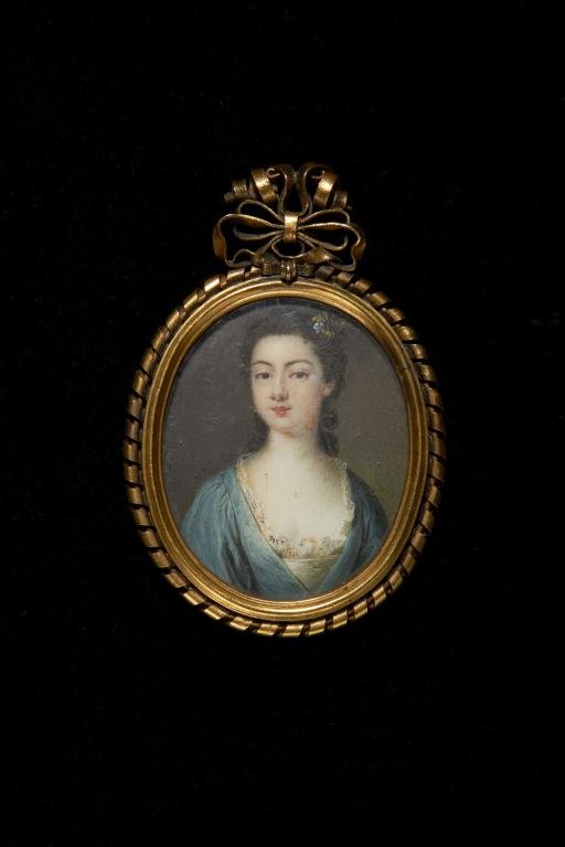 HAND PAINTED PORTRAIT MINIATURE OF A LADY: With flowers in her hair in ornate gilt frame with earlier inscription. English, mid 18th century. H 6 cm. (2 3/8 in.)