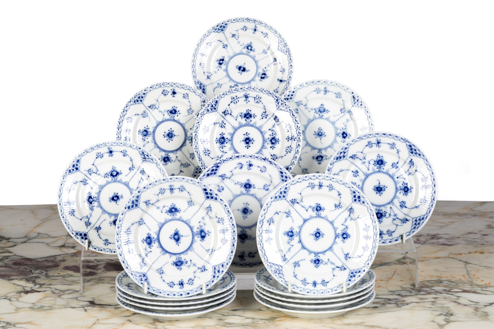 TWENTY ROYAL COPENHAGEN BLUE FLUTED BREAD PLATES: 20 bread and butter plates in the half lace pattern, style #575 Dia.: 16 cm (6 1/4 in.)