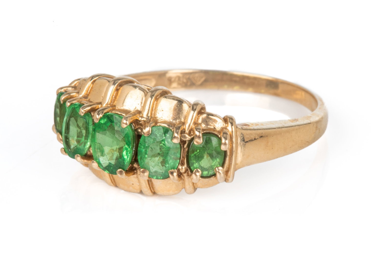 14K GOLD AND GREEN GEMSTONE DRESS RING, 3.3g: A 14k yellow gold five-stone dress ring, set with five oval shaped green gemstones, marked 14k, size 7 1/2.