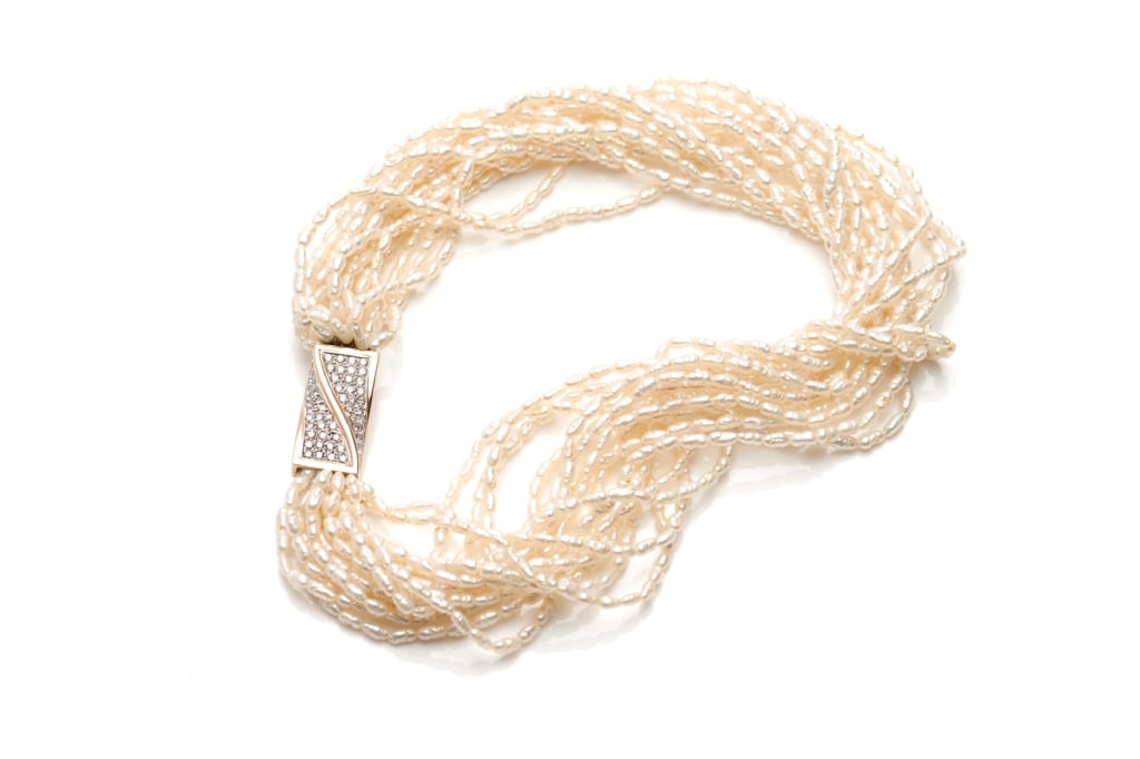 FRESH WATER PEARL NECKLACE WITH DIAMOND CLASP: Multi-strand fresh water pearl necklace, consisting of fifteen individual strands of "rice" shaped fresh water pears, measuring approx. 6x3 mm. Elaborate clasp of 14k yellow and white goldin rectangul