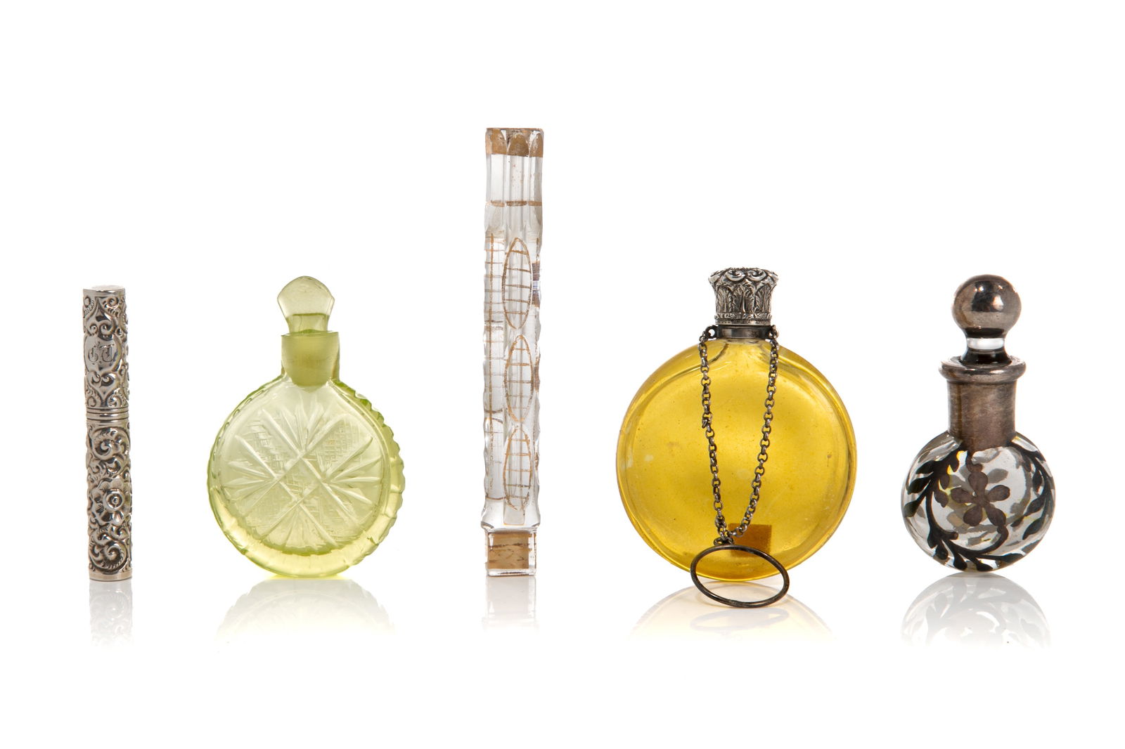 FIVE GLASS & SILVER BOTTLES: Vaseline cut glass bottle, flat yellow glass bottle with English twist silver top and chain, silver deposit bottle, antique glass bottle and silver needle case marked sterling. English, 19th C. H. of