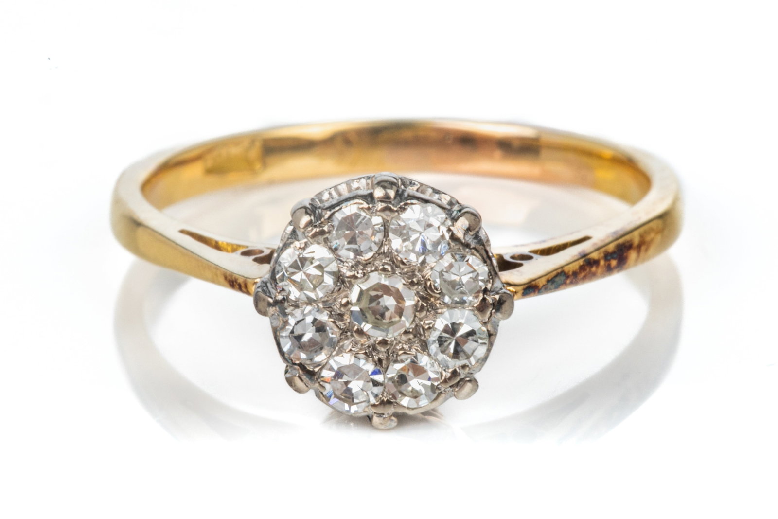 ANTIQUE 18K GOLD AND DIAMOND CLUSTER RING, 3.1g: An 18k white and yellow gold dress ring, the cluster comprising of eight round diamonds, marked 18k, size 6.
