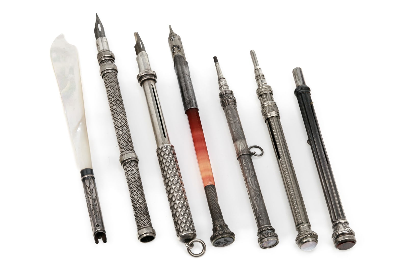 GROUP OF ANTIQUE SILVER MECHANICAL PENCILS: Including two propelling pencils with gemstone set finials, two propelling pencil chatelaines, a double ended propelling pencil, and an agate and silver dip pen. Together with a silver and mother of p